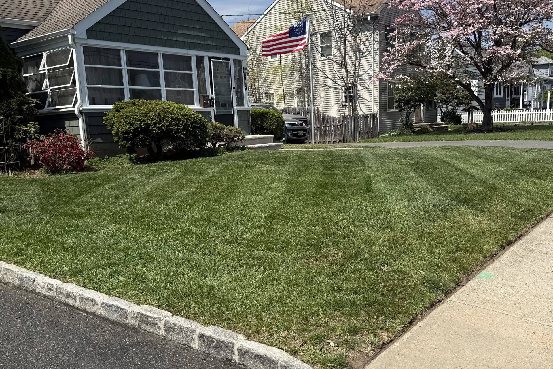 A freshly striped front lawn with a clean curb edge